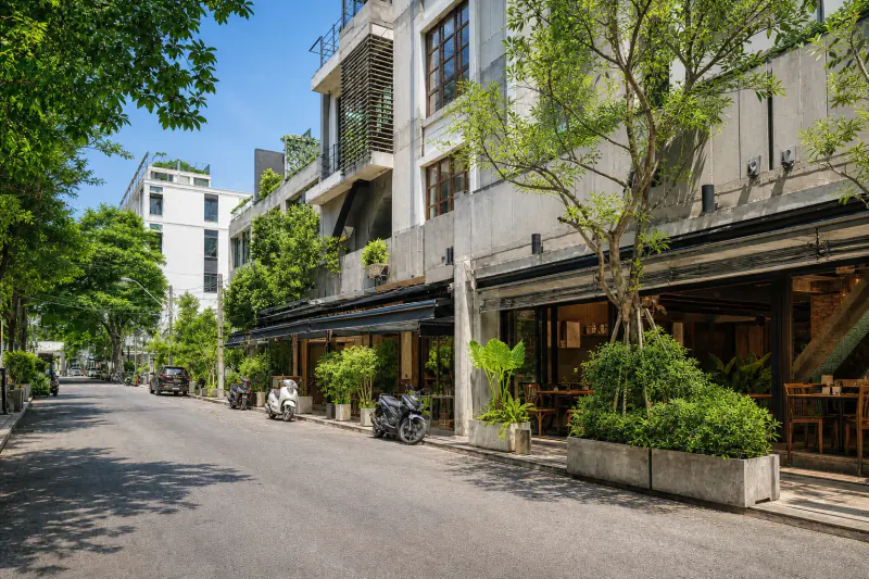 A tree-lined Thong Lo side street with restaurants